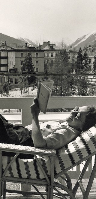 Morosani History A guest takes a sunbath on the balcony of the Morosani Hotel in the history