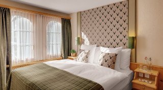 Large bed at the "Posthotel" Double Superior Room in Davos