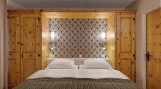 Large double bed at the Double sport room of "Haus Poschiavo"
