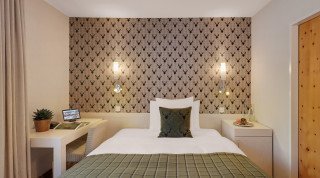 Double bed at the Single Standard room of the Morosani "Haus Poschiavo"