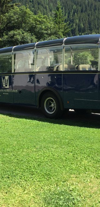 Blue oldtimer bus of the Morosani Hotel in Davos