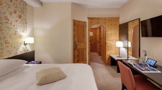 Double bed of the Villa room at the Morosani "Schweizerhof" in Davos